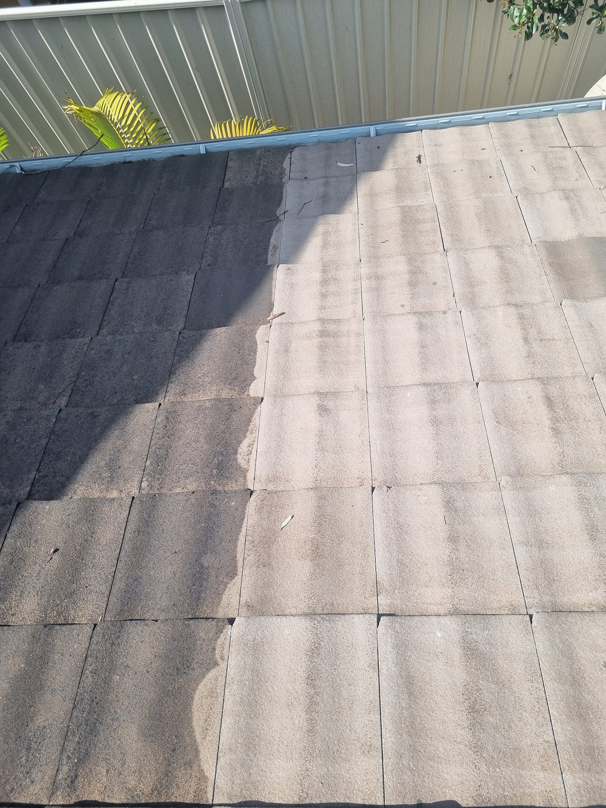 Concrete tile roof, sharp line between cleaned and uncleaned sections